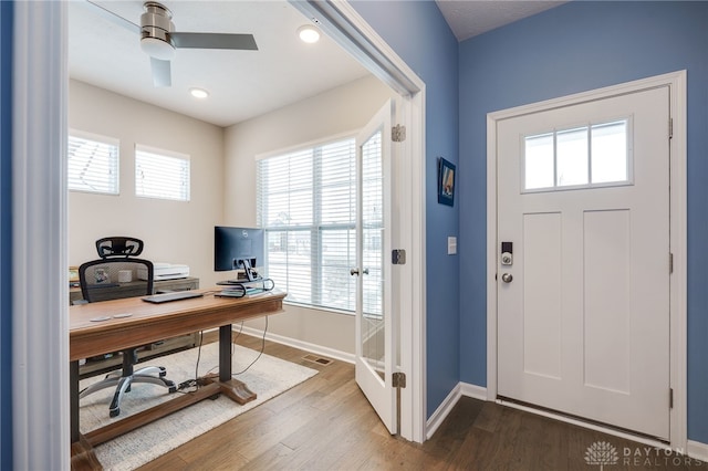 entryway with wood-type flooring, ceiling fan, and a healthy amount of sunlight