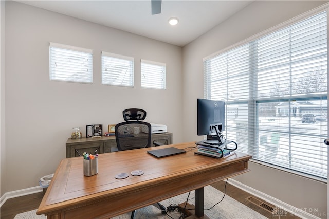 office area with dark hardwood / wood-style flooring and a wealth of natural light