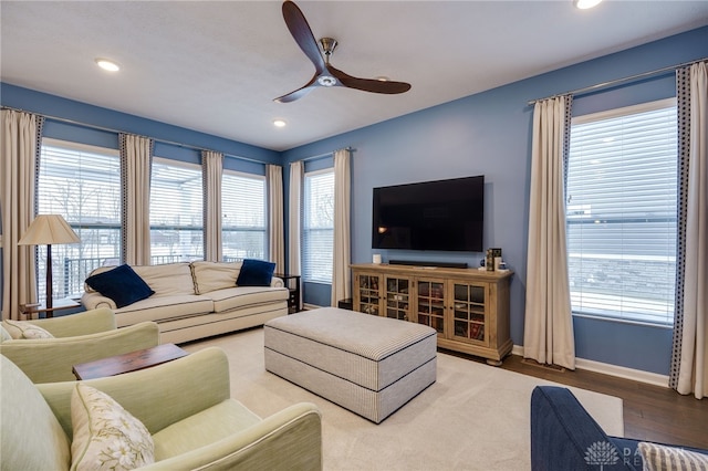 living room with a wealth of natural light, hardwood / wood-style floors, and ceiling fan