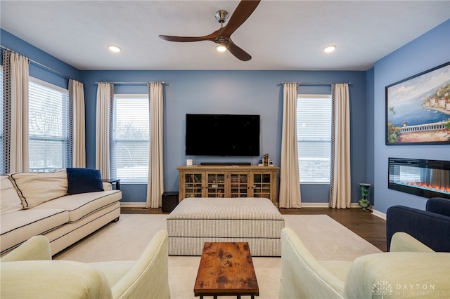 living room featuring hardwood / wood-style flooring and ceiling fan