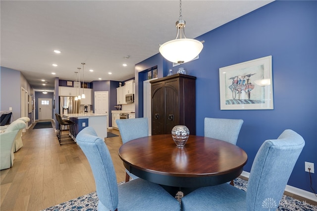 dining room with light hardwood / wood-style flooring and sink