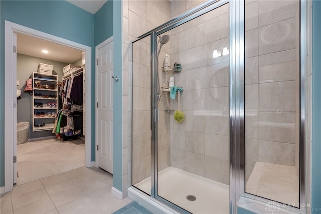 bathroom with a shower with door and tile patterned flooring