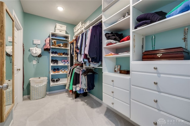 spacious closet with light colored carpet