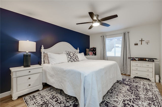 bedroom featuring light hardwood / wood-style floors and ceiling fan