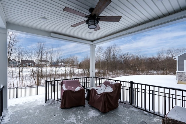 snow covered patio featuring ceiling fan and a grill