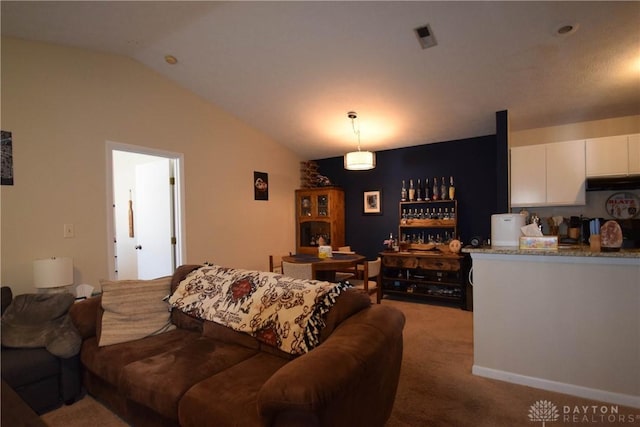 living room featuring vaulted ceiling and carpet