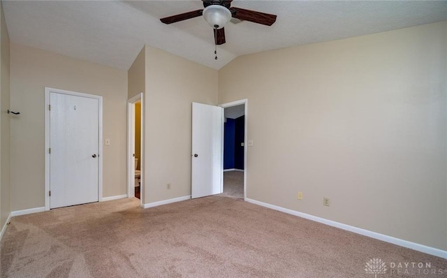 unfurnished bedroom with lofted ceiling, light colored carpet, and ceiling fan