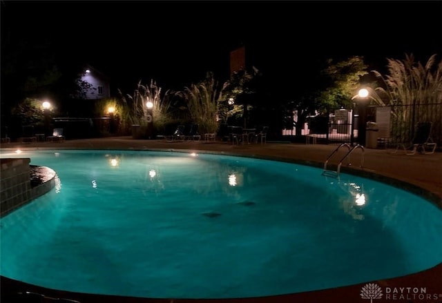 view of pool at night