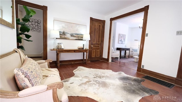 sitting room featuring dark wood-type flooring