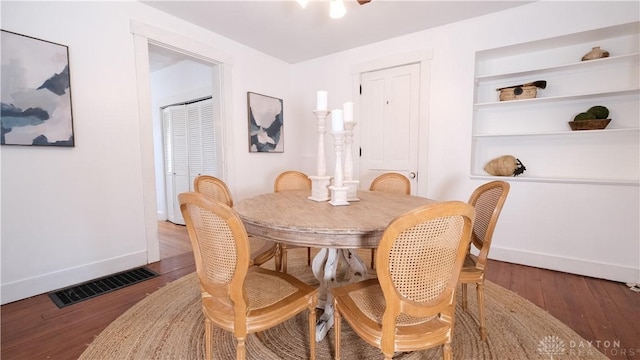 dining area with dark hardwood / wood-style flooring