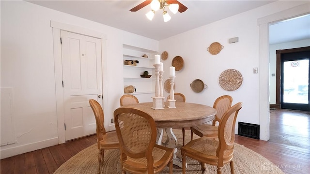 dining area with hardwood / wood-style flooring, ceiling fan, and built in shelves