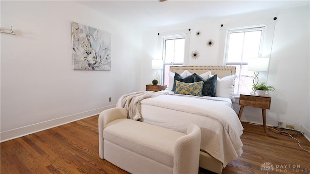 bedroom with dark hardwood / wood-style flooring