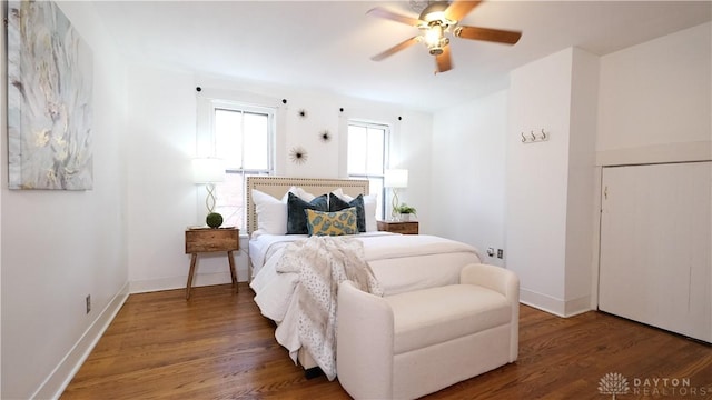 bedroom with dark hardwood / wood-style floors and ceiling fan