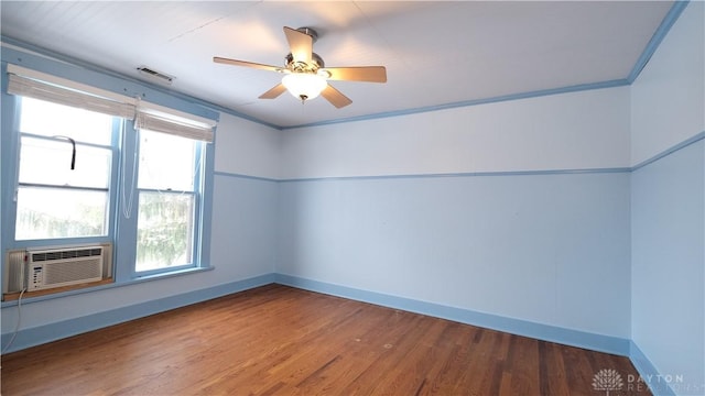 spare room featuring hardwood / wood-style floors, ceiling fan, cooling unit, and ornamental molding