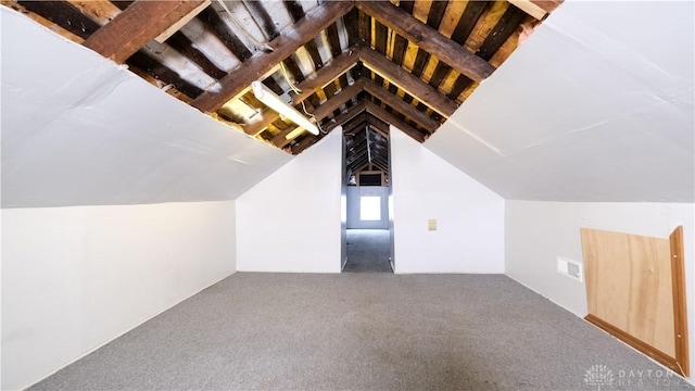 additional living space featuring lofted ceiling