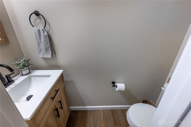 bathroom featuring hardwood / wood-style floors, vanity, and toilet