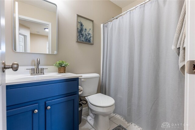 bathroom with tile patterned flooring, vanity, and toilet