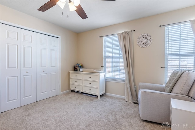 sitting room featuring light carpet and ceiling fan