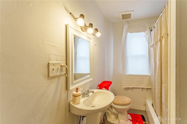 full bathroom with shower / tub combo, toilet, tile patterned floors, and sink