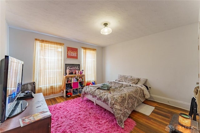 bedroom with hardwood / wood-style flooring and a textured ceiling