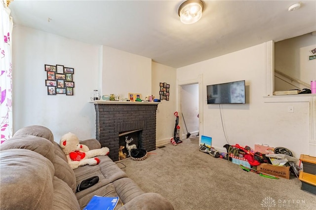 carpeted living room featuring a brick fireplace