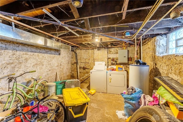 basement featuring electric panel, washer and clothes dryer, and gas water heater