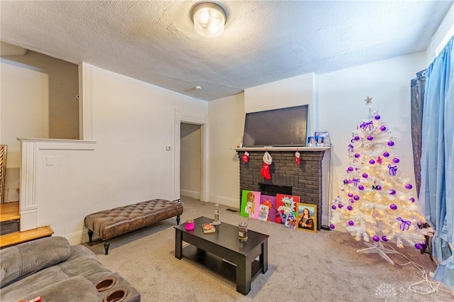 carpeted living room with a fireplace and a textured ceiling