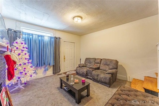 carpeted living room featuring a textured ceiling