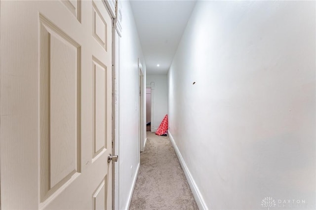 hallway with light colored carpet