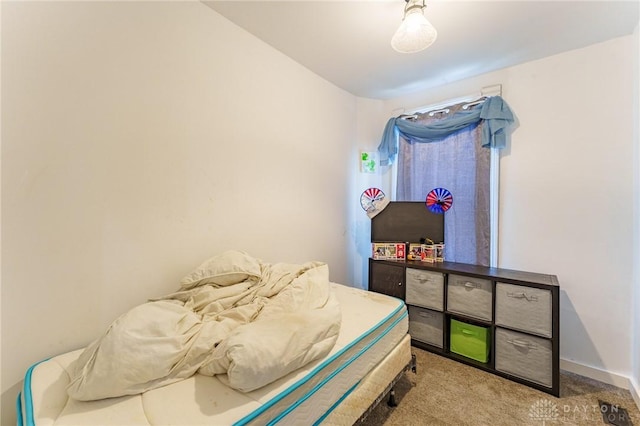 bedroom featuring light carpet