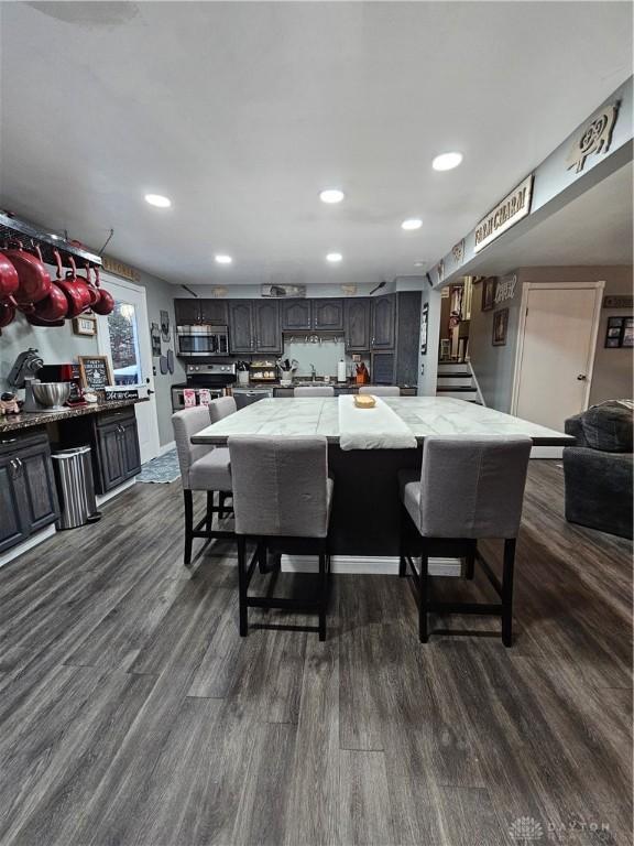 dining space featuring dark wood-type flooring