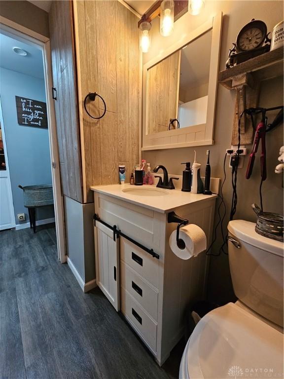 bathroom featuring hardwood / wood-style floors, vanity, and toilet