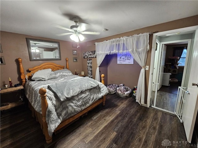 bedroom with dark hardwood / wood-style flooring and ceiling fan