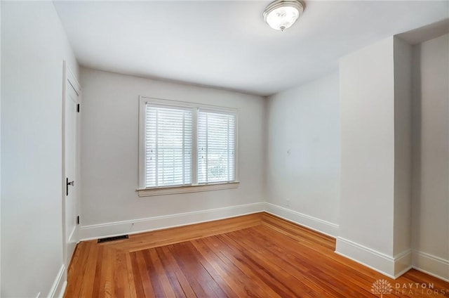 spare room featuring hardwood / wood-style flooring