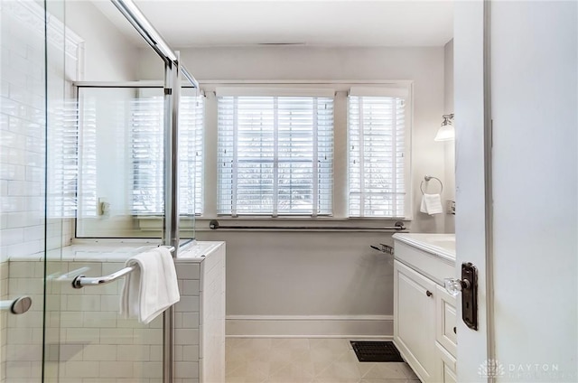 bathroom featuring tile patterned floors, walk in shower, and vanity