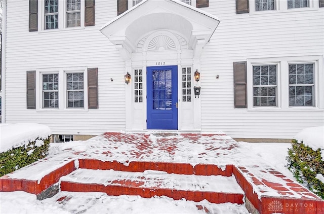 view of snow covered property entrance