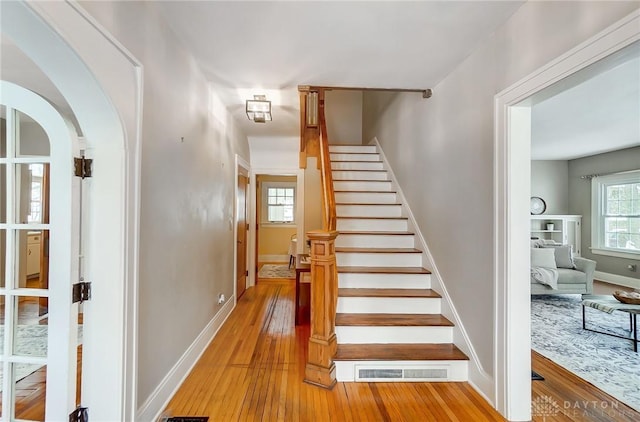 stairs featuring hardwood / wood-style floors