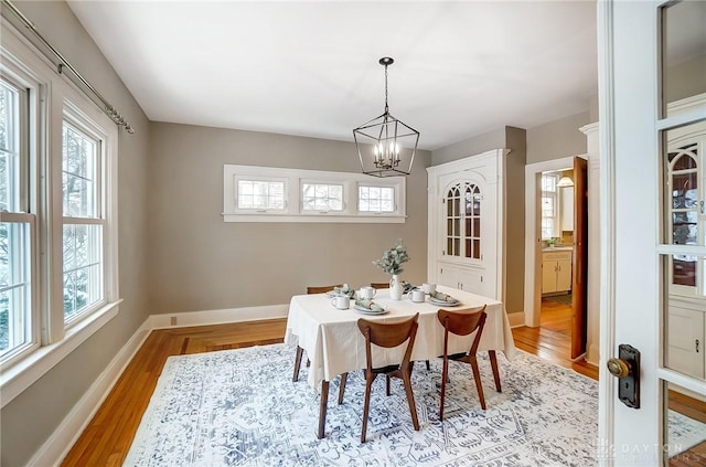 dining area featuring an inviting chandelier and light hardwood / wood-style flooring