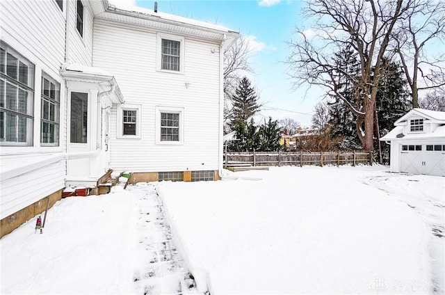 yard layered in snow featuring an outbuilding