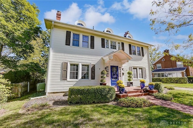 colonial-style house with a front yard