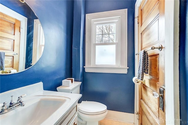 bathroom featuring toilet and vanity