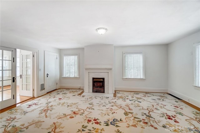 unfurnished living room featuring a brick fireplace