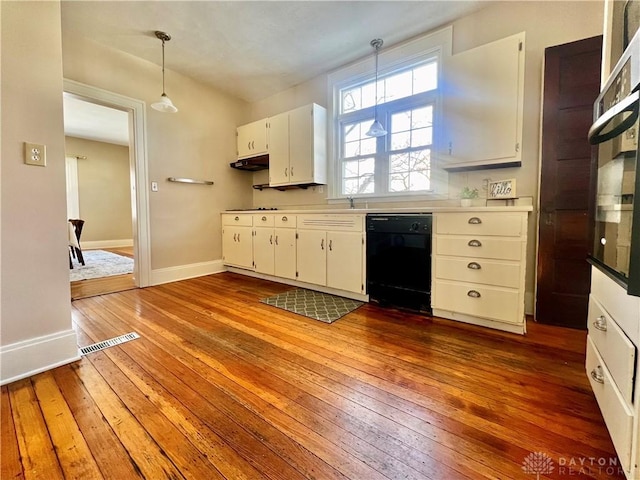 kitchen featuring dark hardwood / wood-style floors, black dishwasher, white cabinets, and decorative light fixtures