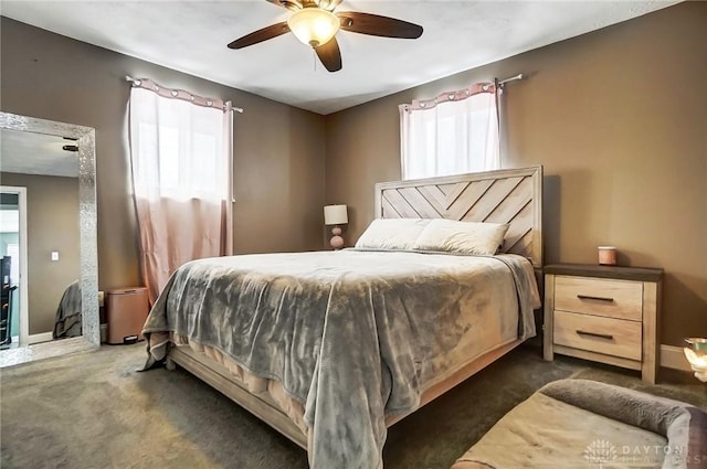 carpeted bedroom with multiple windows and ceiling fan