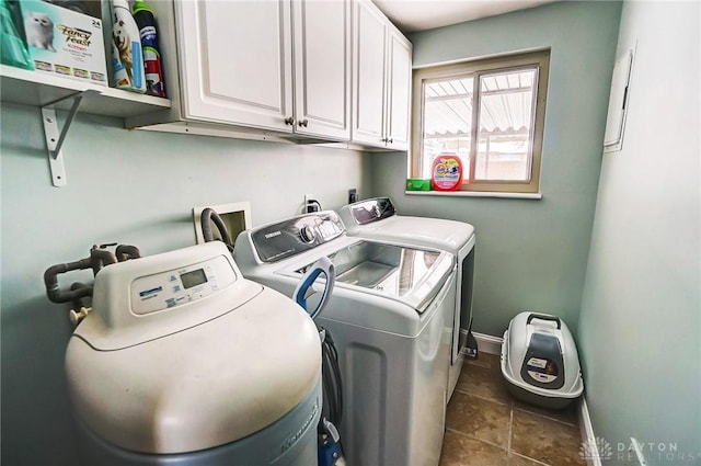 laundry area with washer and dryer and cabinets