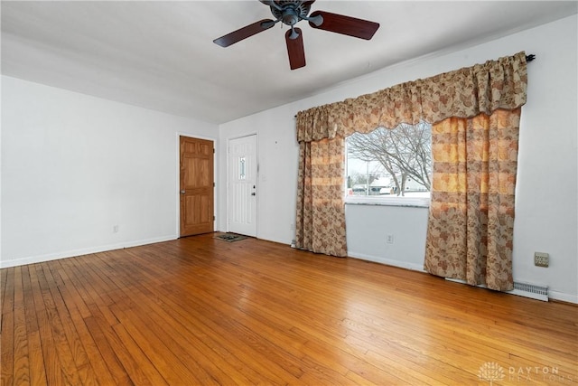 unfurnished room with hardwood / wood-style floors and ceiling fan