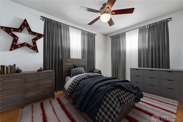 bedroom with ceiling fan and wood-type flooring