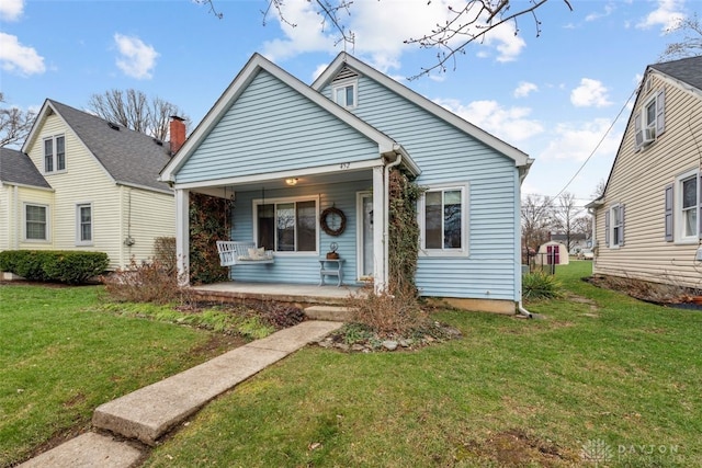 bungalow-style house with a front lawn and a porch