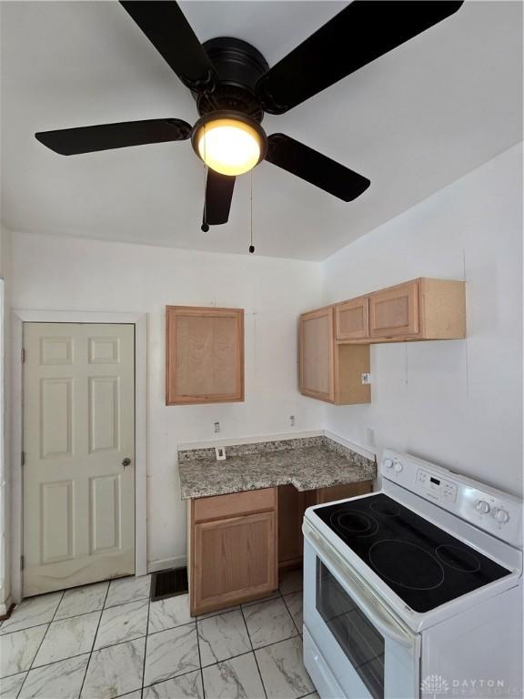 kitchen featuring ceiling fan and white electric range