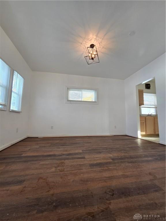 empty room with dark hardwood / wood-style flooring